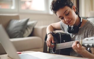 Can listening to rock music help improve my guitar skills?