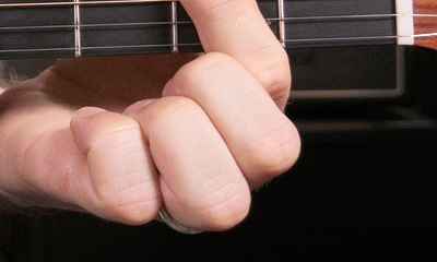What is the difference between open and closed chords, and which should I learn first?